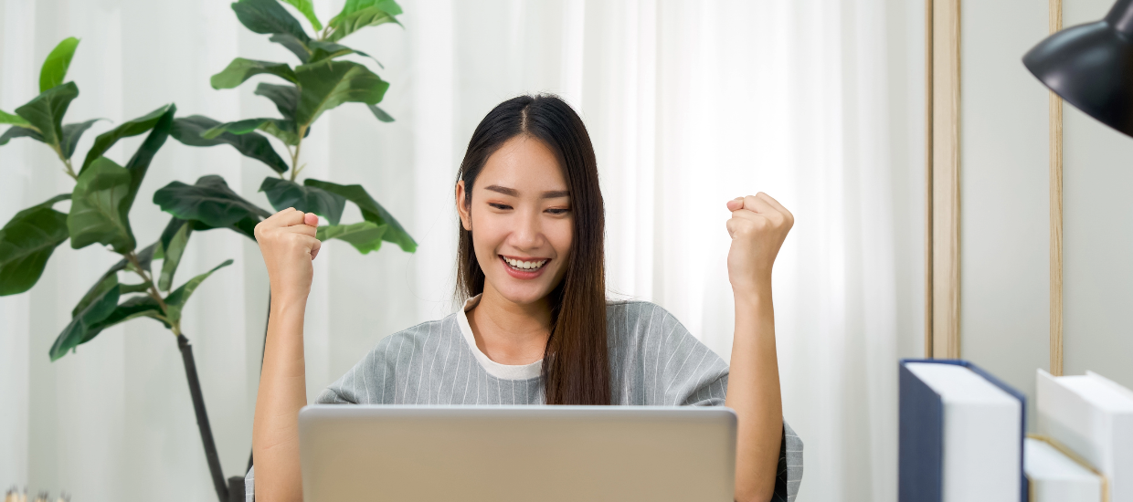 student excited on laptop